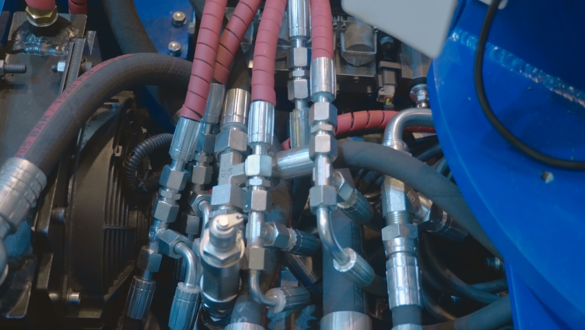 A unit of industrial equipment where the accumulation of hydraulic hoses and valves ensures the operation of the mechanism. Close up. Shot in motion Royalty-Free Stock Footage #1090323747
