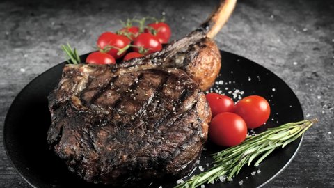 Ribeye Tomahawk Steak, Irish Beef, grilled ,cuts with a knife. High quality 4k footage