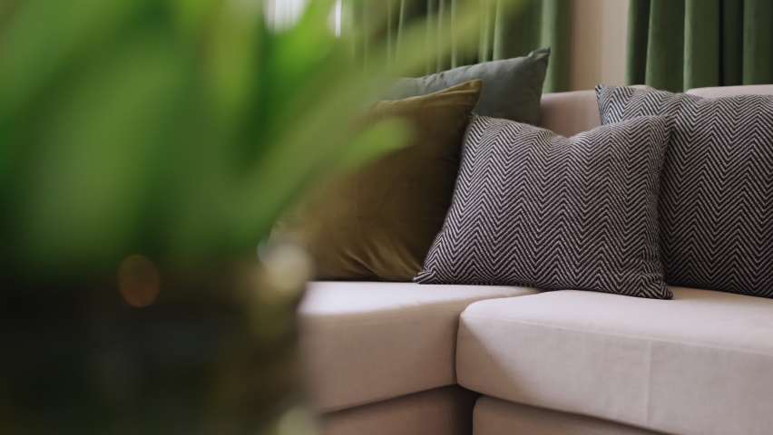 home interior design detail of Modern clean living room with soft and cozy sunlight pillow upholsty curshion arrange on white sofa dolly shot close up,home sweet home background Royalty-Free Stock Footage #1090324399