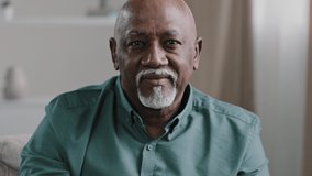 African American unwell unhealthy gray haired elderly 60s old biracial man coughing with flu symptoms sitting on couch home sick ill mature grandfather grandpa with throat pain coronavirus infection - Powered by Shutterstock - Get 15% off with code: PIKWIZARD15