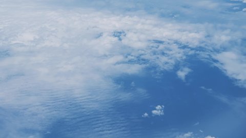 Sky view from the window of an airplane Blue sky and flowing white clouds 4K UHD
