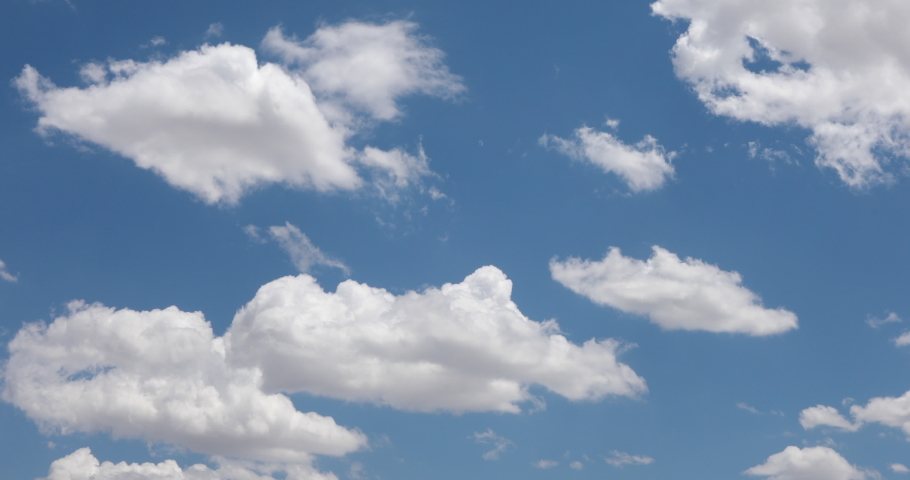 Beautiful white clouds in a blue sky background. Cotton clouds in blue sky. Natural view of clouds. Meteorology and environment concept background. Cumulus clouds background. Drone high view. Royalty-Free Stock Footage #1090327595