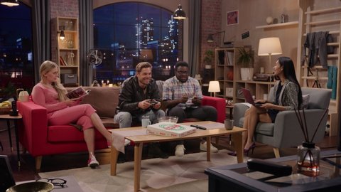 Television Sitcom: Leisure Time Part 2. Four Friends have Fun at Home. Fun TV Show Girls Reading and Working, Guys Playing Video Games on a Couch. Comedy Series on Playback Channel, Streaming Service