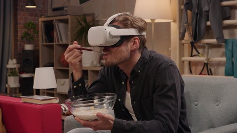 Television Sitcom Concept: Guy Using Virtual Reality Headset Eating Breakfast in Living Room. Funny Sketch About Internet Addiction. Comedy Series Broadcast Network Channel, Streaming Service