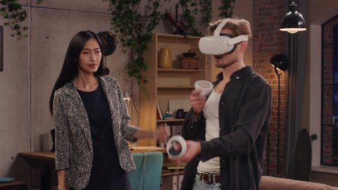 Television Sitcom Living Room: Couple Has Relationship Problems. Funny Sketch About Guy Having VR Metaverse Addiction, Girl Confronts Him. Comedy Series Broadcast Network Channel, Streaming Service