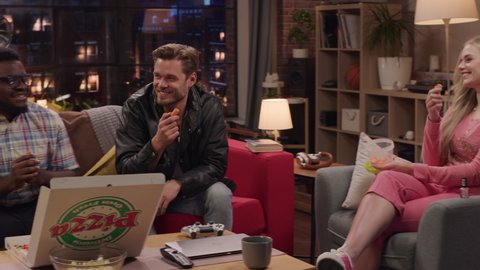 Television Sitcom Concept. Four Diverse Friends having Fun in Living Room. Funny Sketch of One Couple Eating Pizza the Other Dieting. Comedy Series Broadcasting on Network Channel, Streaming Service