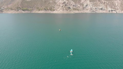 man kayaking in blue lake. Summer day in Mendoza, Argentina.