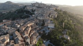 4k ascending aerial video of golden hour at the medieval town Montepulciano in Tuscany, Italy at sunset