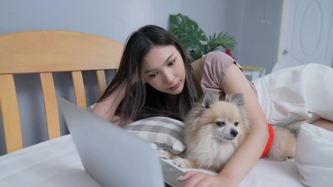 Holiday concept of 4k Resolution. Asian girls working with computers in the bedroom.