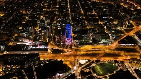 Barcelona skyline with modern office buildings at night, Catalonia, Spain. Aerial view of Torre Agbar (Torre Glòries)