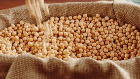 Grocery, taking chickpeas close-up. Harvest season. Cooking healthy breakfast, vegetarian diet. Touching grains. Food video concept.