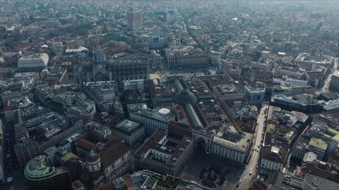 Milan, Italy. May 10, 2022. Aerial view of Milan city from above. Flying over Milan city center with people walking down the narrow streets of Milan and Duomo di Milano cathedral.