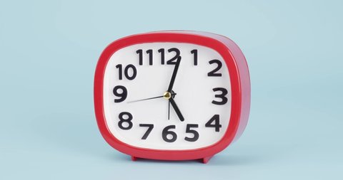 Red Alarm clock isolated on blue background, Showtime 05.02 am.
