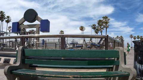 Venice Beach, California, USA - May 15, 2022:  Moving view of outdoor weightlifting equipment at famous Muscle Beach in Los Angeles, California.