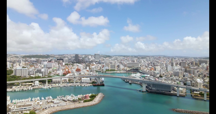 [Drone] Tomari Ohashi in Naha City, Okinawa Prefecture and the cityscape of Naha City Royalty-Free Stock Footage #1090345599