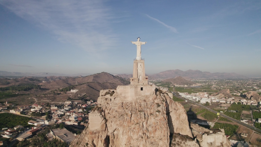 Drone view of falcon soaring around Christ of Monteagudo landmark in Murcia