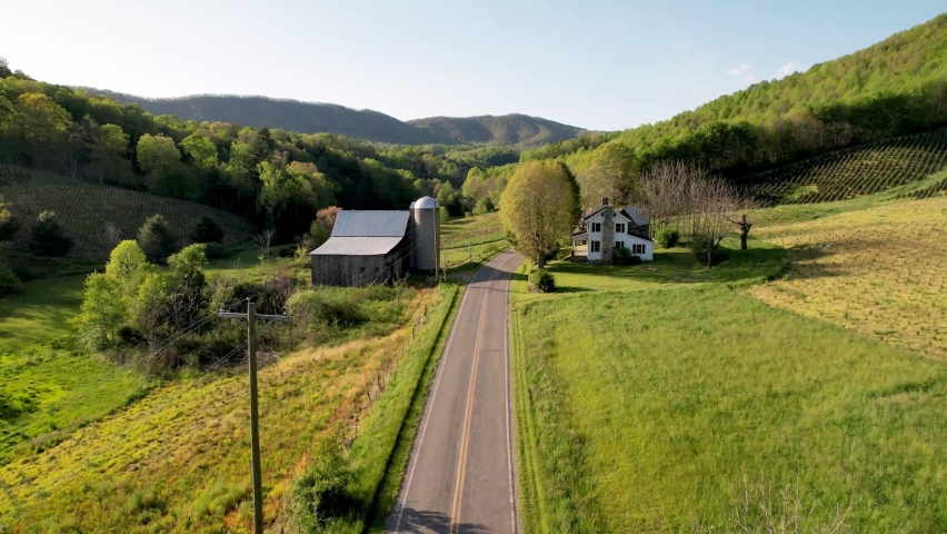 aerial farmhouse and barn down roadway near bethel nc, north carolina near boone and blowing rock north carolina