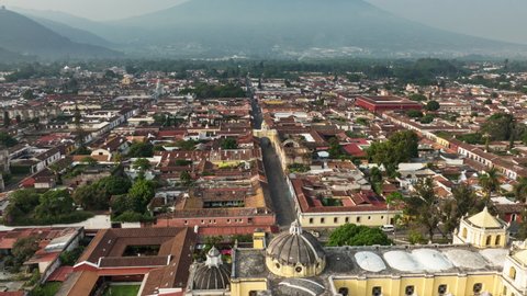 Slow aerial rotating hyperlapse of the arch and churches in downtown Antigua, Guatemala.