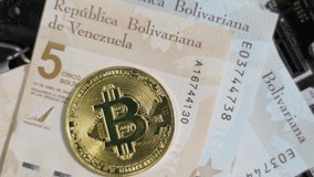 Bitcoin, cash Bs Bolivar Digital Venezuela bills rotate on circuit board, close up - Powered by Shutterstock - Get 15% off with code: PIKWIZARD15