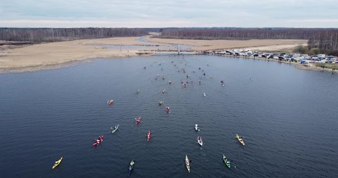 People with canoes kayaks on a competition. Going from lake to river. Outdoor activities, water sports. Pro athletes competition. Amazing view, winter sports. Rowing team. High quality FullHD footage