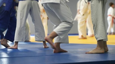 Children do a judo grip. Legs close-up