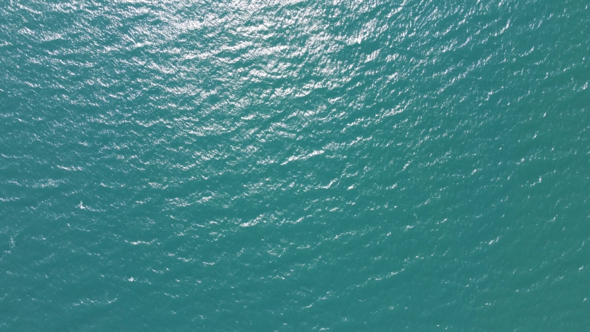 
Aerial bird's eye view of turquoise sea white small waves on sunny day Royalty-Free Stock Footage #1090354245