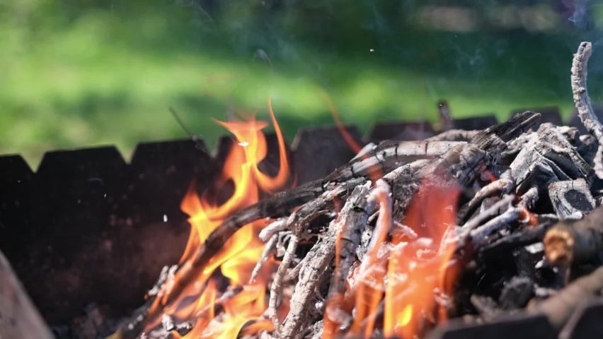 Firewood burning - slow motion video of Tongues of fire and smoke from coals in the grill  | Shutterstock HD Video #1090354457