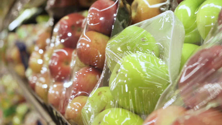 Apples in plastic wrap. Fresh fruits in the store | Shutterstock HD Video #1090358003
