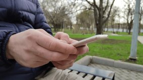 Young man using his smartphone for online shopping, games, communication and work. Mobile phone in men's hands. 4k, footage, close-up, horizontal video