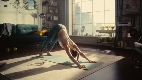 Athletic Young Female Exercising, Stretching and Doing Yoga in the Morning in Her Bright Sunny Room at Home. Beautiful Woman in Sports Clothes Practising Different Asana Poses on the Mat.