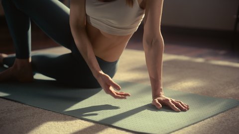 Close Up of a Young Beautiful Female Exercising, Stretching and Practising Yoga in the Morning in Her Bright Sunny Loft Apartment. Healthy Lifestyle, Fitness, Wellbeing and Mindfulness Concept.