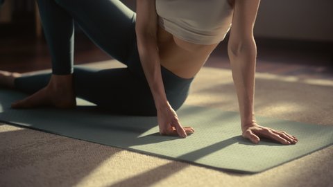 Close Up of a Young Beautiful Female Exercising, Stretching and Practising Yoga in the Morning in Her Bright Sunny Loft Apartment. Healthy Lifestyle, Fitness, Wellbeing and Mindfulness Concept.