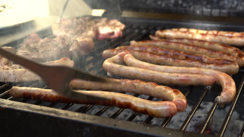 Grilling sausages on barbecue grill. Selective focus. slow-motion 4k. | Shutterstock HD Video #1090363125