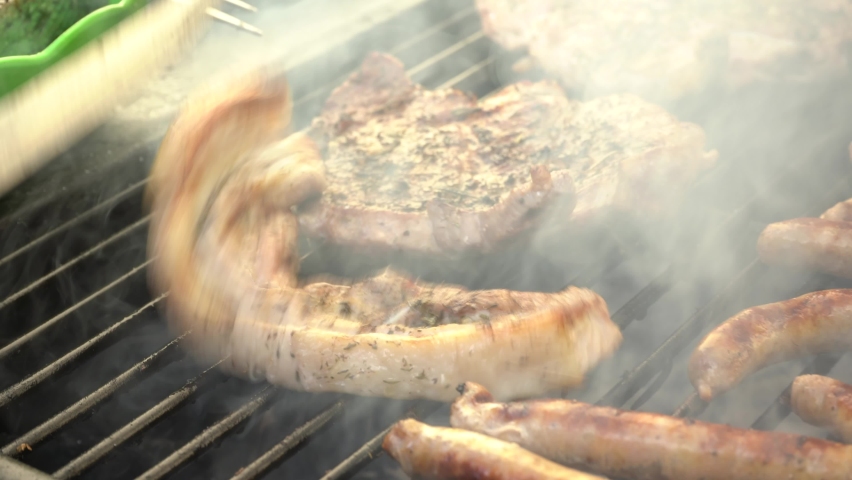 Sausages and steak on the grill. Selective focus. 4k video. | Shutterstock HD Video #1090363447