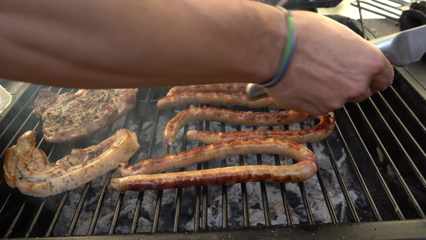 Sausages and steak on the grill. Selective focus. 4k video. | Shutterstock HD Video #1090363451