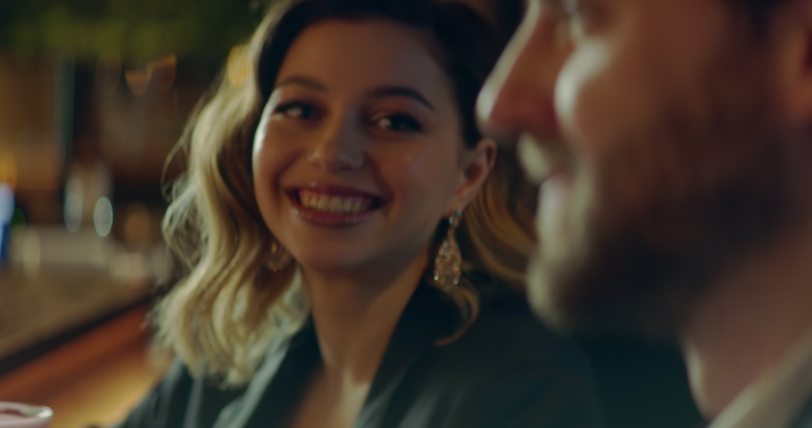 CU Portrait of beautiful Caucasian couple having a date in a stylish restaurant, talking and laughing. Shot with 2x anamorphic lens Royalty-Free Stock Footage #1090365363