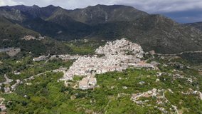 Aerial perspective of Ojen village, small town  located in the mountains, in the heart of the Costa del Sol, not far from Marbella. In background beautiful mountains of 