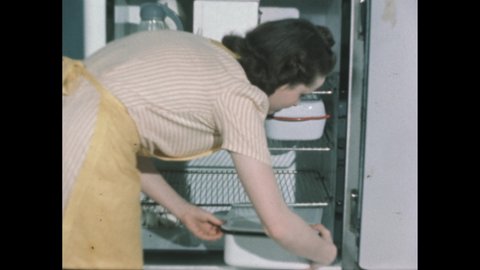 1940s: Slate. Woman looks at a bruised peach. Slate. Woman opens a refrigerator door and puts in a covered tray at the bottom. Slate. Women unwrap fruit and place them in a tray.