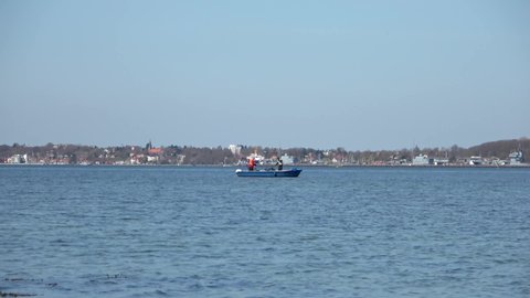 Two men fishing from a boat on the Baltic Sea off Eckernfoerde.