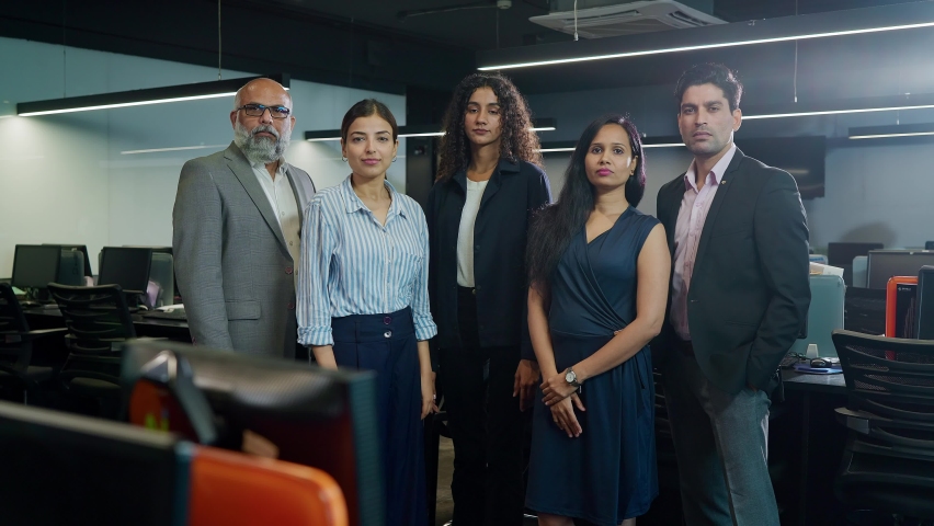 A group of attractive confident motivated Asian Indian male and female or mixed Gender formal corporate office employees startup business people with arms crossed or folded arms looking at the camera. Royalty-Free Stock Footage #1090367685