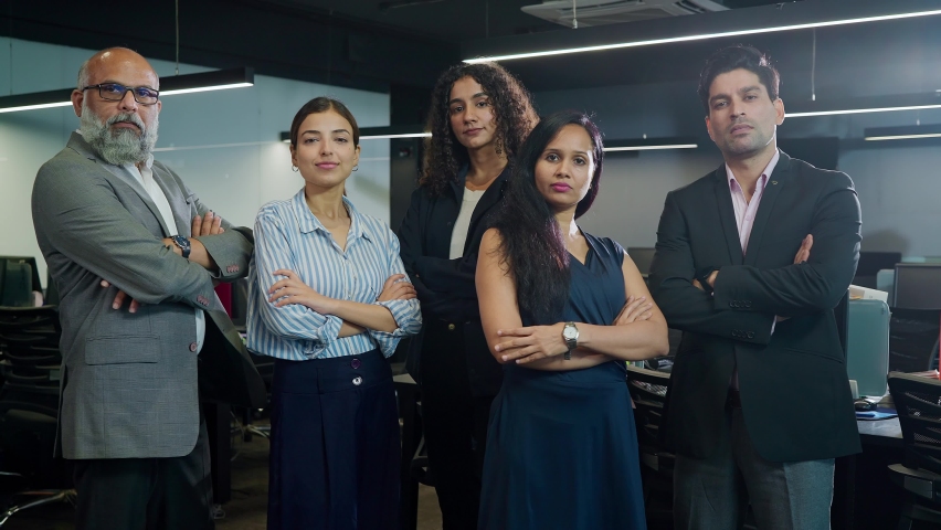 A group of attractive confident motivated Asian Indian male and female or mixed Gender formal corporate office employees startup business people with arms crossed or folded arms looking at the camera. | Shutterstock HD Video #1090367685