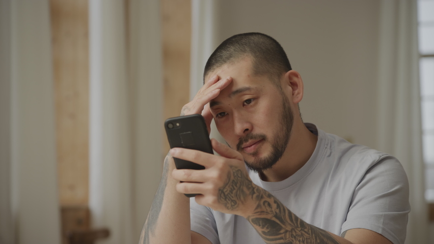 Close up of a man recieving bad news on his smart phone in slow motion | Shutterstock HD Video #1090369577