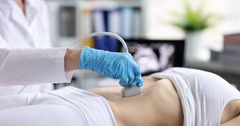 Doctor doing ultrasound examination of internal organs closeup 4k movie slow motion