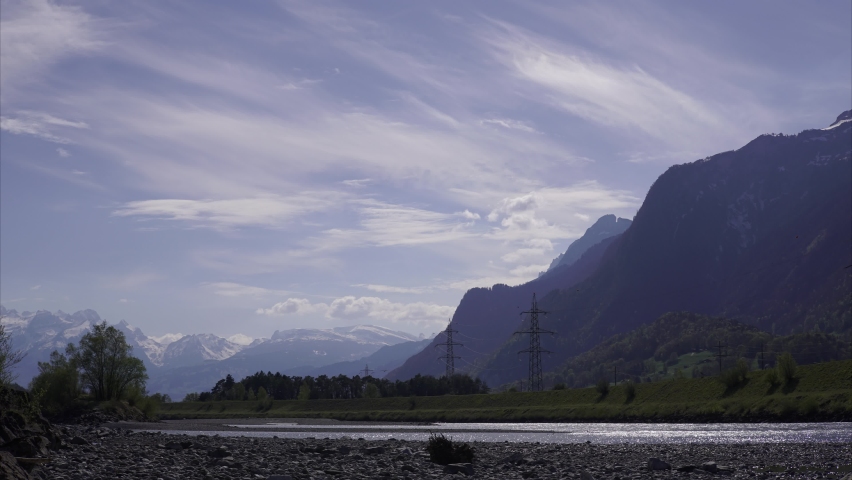 Time lapse beautiful mountains, river, high voltage power lines 