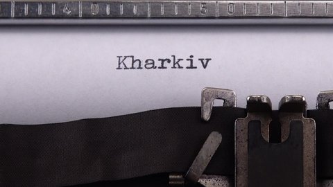 Typing name of Ukrainian city "Kharkiv" on retro typewriter.