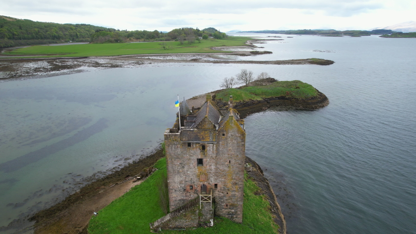 Aerial close up shot of stalker castle tower house at Loch Linnescotland united kingdom Europe.
