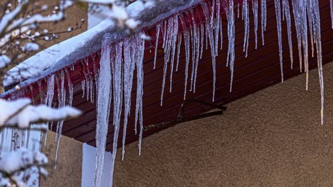 Process Of Icicles Forming At Rain Gutter On The Roof. Time-lapse.