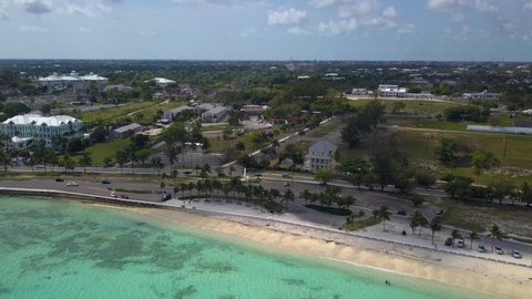 Aerial view of the Western Esplande Beach and the coast of Nassau in the Bahamas islands - pan, drone shot