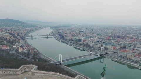 circling birds eye view of the two sections of the city buda and pest the capital of hungary budapest showing two of the many bridges over the river danube in the wide angle shot