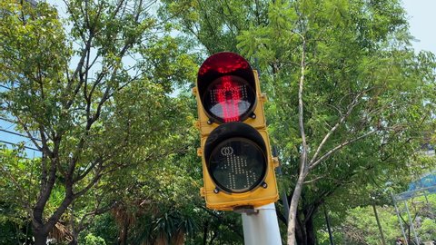 View Of Red Traffic Light In Shape Of Human On Lamppost In Mexico City